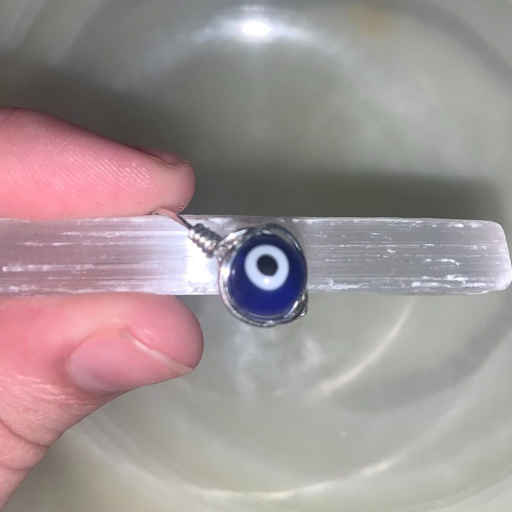 Silver wire-wrapped evil eye ring